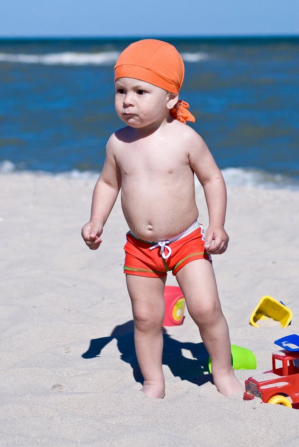 Boy playing in the sand on the beach