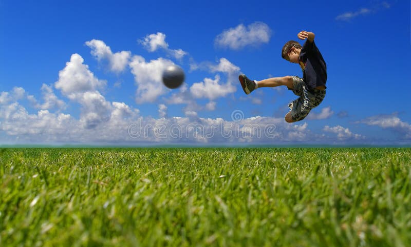 Ragazzo a giocare a calcio contro il cielo.