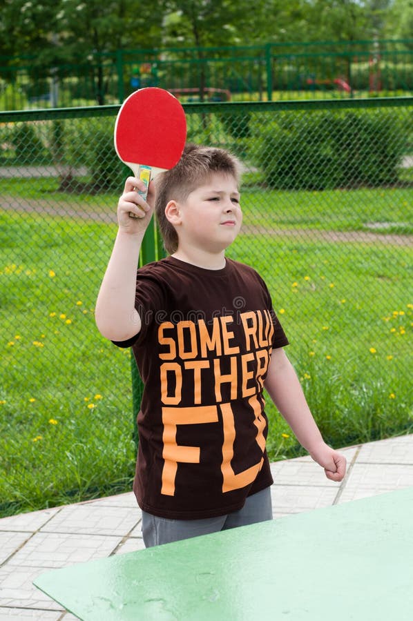 Boy playing table tennis stock photo. Image of action 24837538