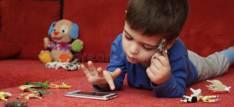 Boy playing on tablet, indoor