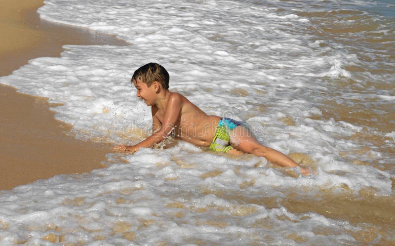 Boy playing in the waves