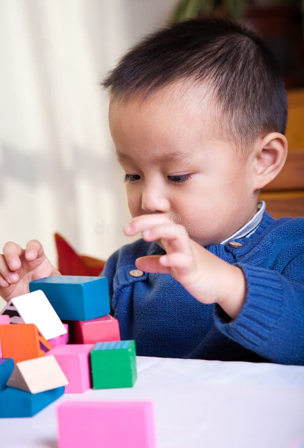 boy playing with wooden blocks