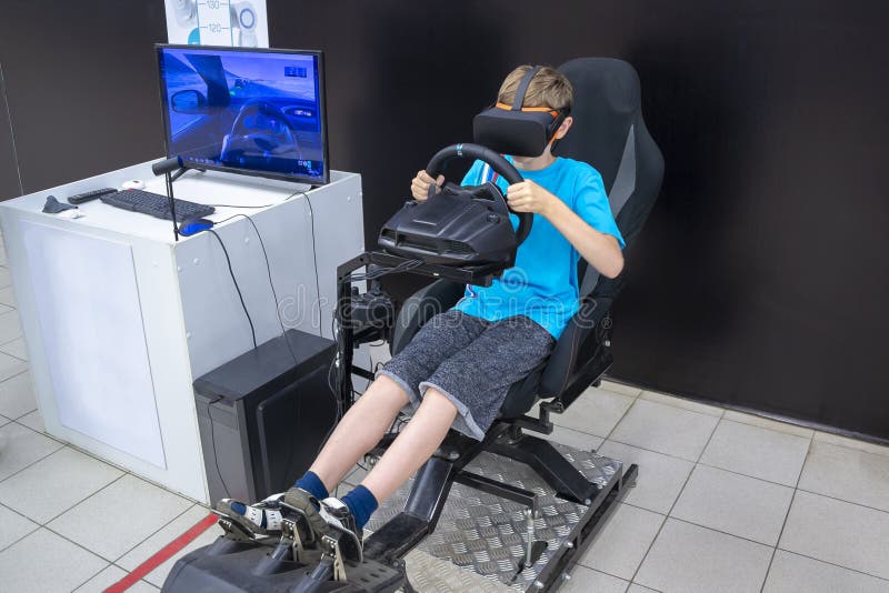 A boy plays on the car simulator stock image A boy plays on the car simulator stock image