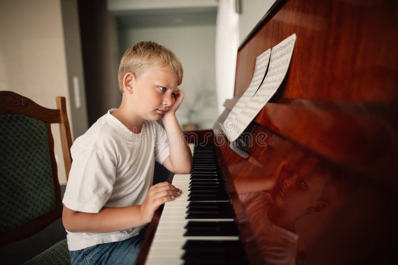 Boy plays piano at home