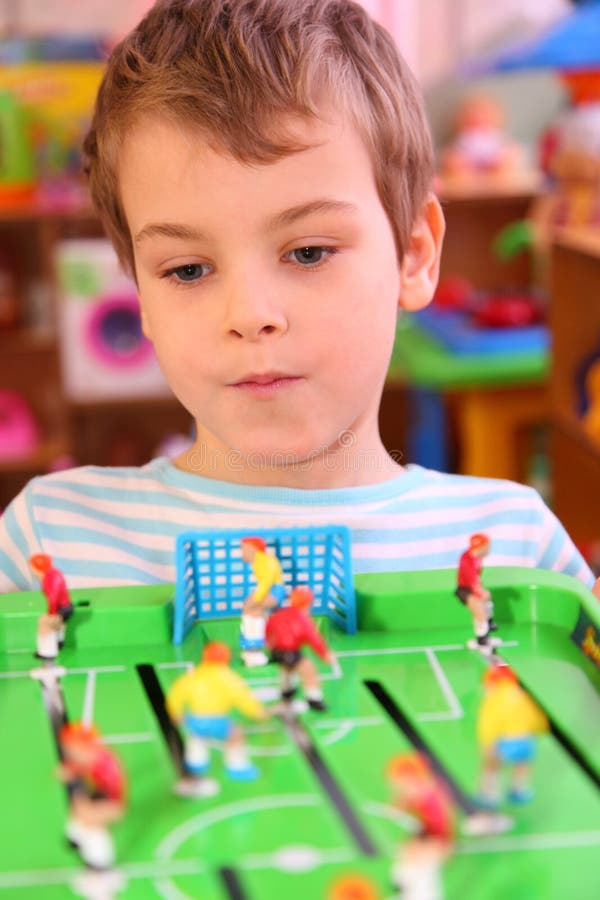 Boy plays in toy football stock image. Image of entertaining 9703919
