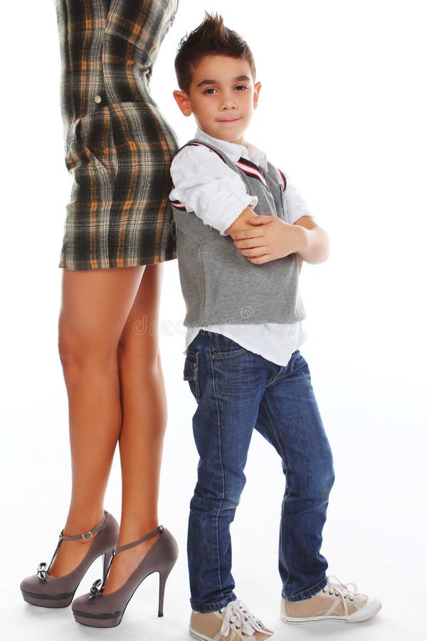 Boy posing near woman`s legs