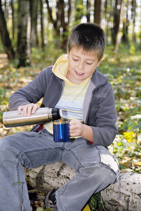 Boy Pouring Tea from Thermos To Cup Stock Photo Image of rural