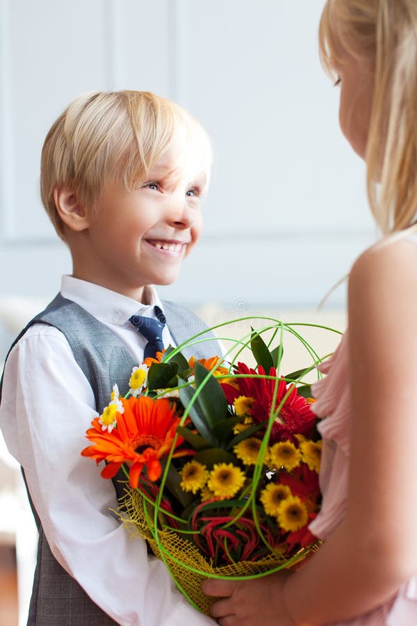 Little Girl Presenting Flowers To Boy Stock Photos Free & Royalty