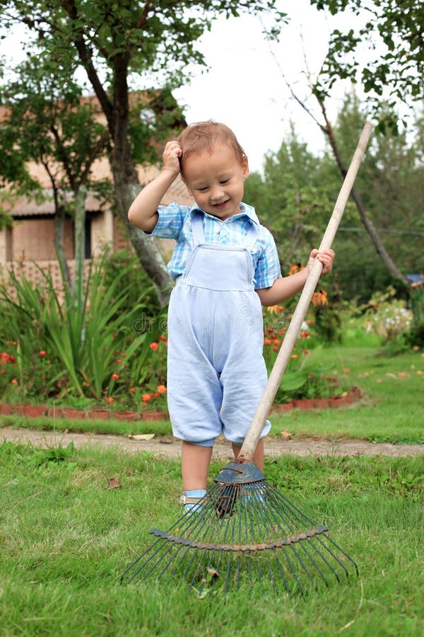 Boy raking in the garden