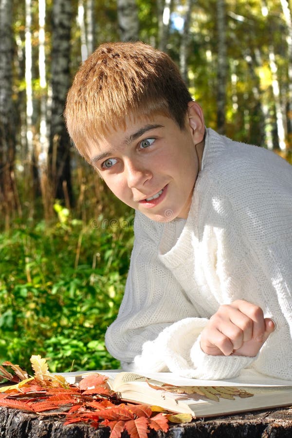Boy reading outdoor stock photos