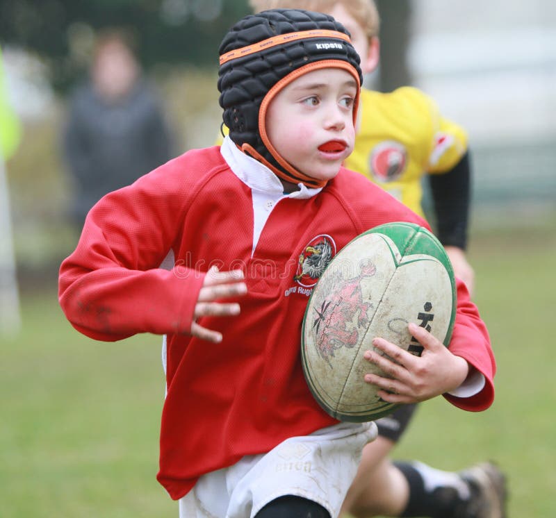 Boy with Red Jacket Play Rugby Editorial Stock Image Image of