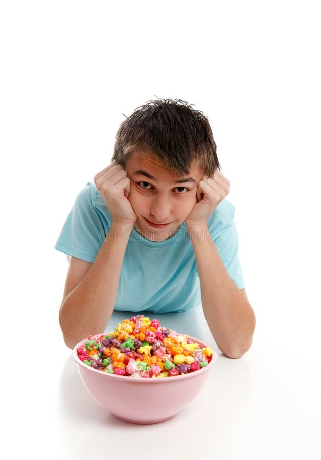 Boy relaxes with bowl of snack food