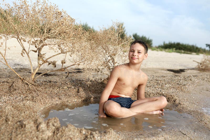 Boy resting on beach of Azov sea