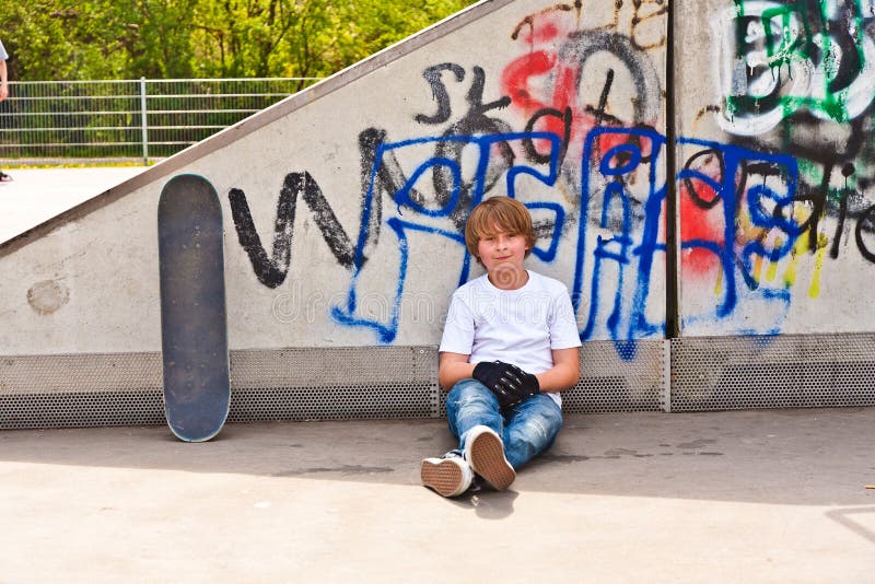 Boy resting with skate board