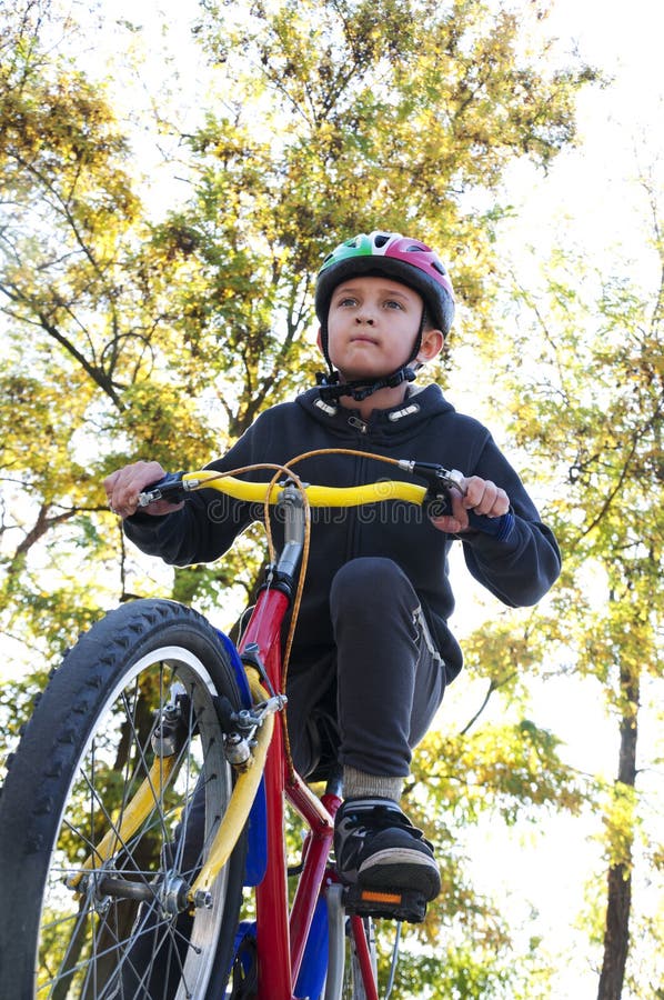 Boy Riding a Bike in the Park Stock Photo - Image of outdoors, nature ...