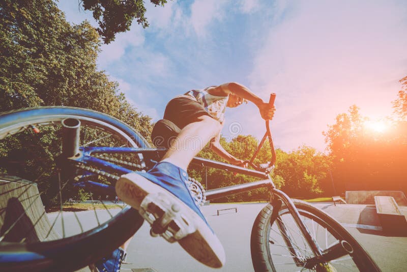 Boy Riding a Bmx in a Park. Stock Photo Image of exhilaration, helmet
