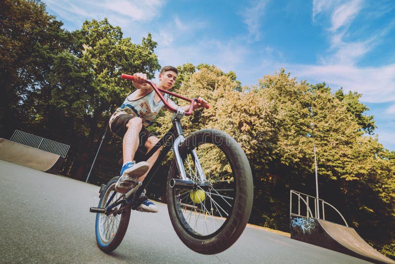 Boy Riding a Bmx in a Park. Stock Photo Image of pursuit, cyclist