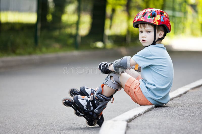 A boy is riding on rollers stock image. Image of roller 65606133