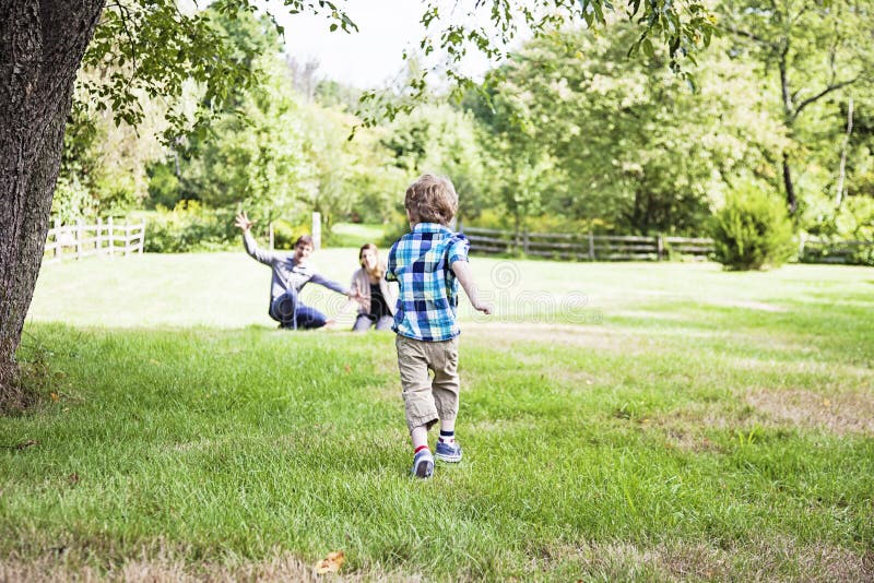 Boy running to parents royalty free stock photography Boy running to parents royalty free stock photography