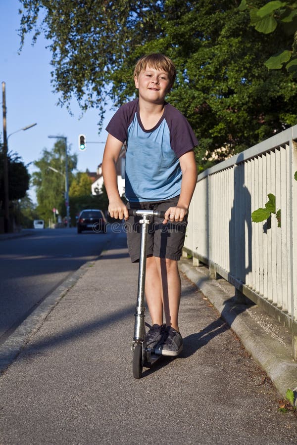 Boy with scooter on the street