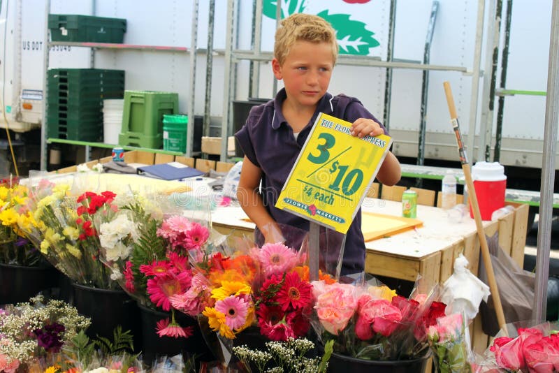 ST. JACOBS , ONTARIO, CANADA - JULY 14 : Boy is selling flowers at the vill...