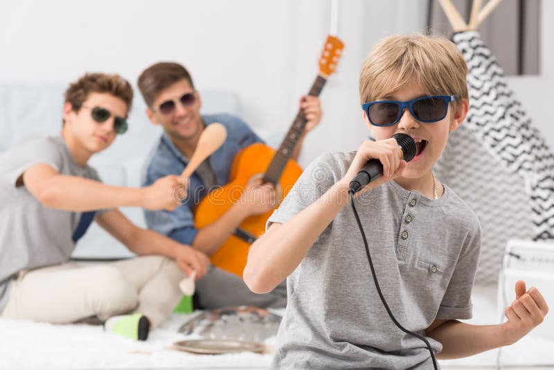 Boy singing to microphone royalty free stock photography Boy singing to microphone royalty free stock photography