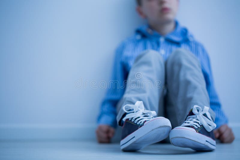 Boy sitting on a floor