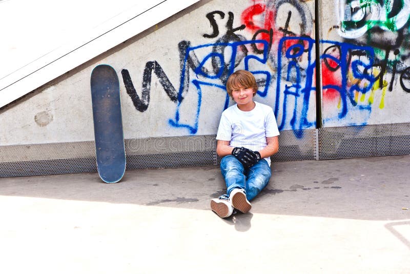 Boy with skate board at the skate park