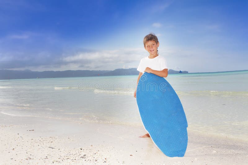 Boy with skim board on sea background