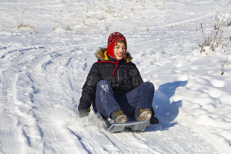 Happy Boy Sliding Down Snow Hill on Sled Outdoors in Winter, Sle Stock  Image - Image of happy, happiness: 260133761