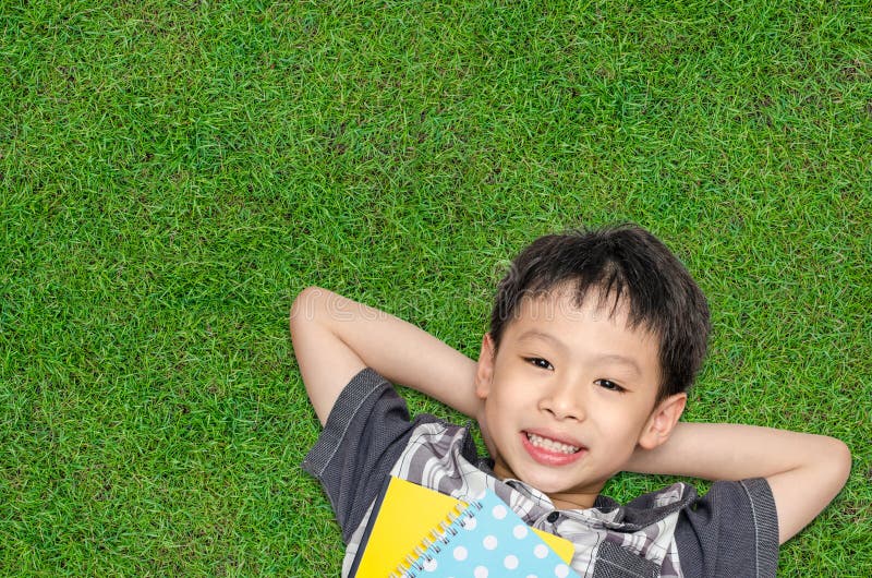 Boy smiles on grass field