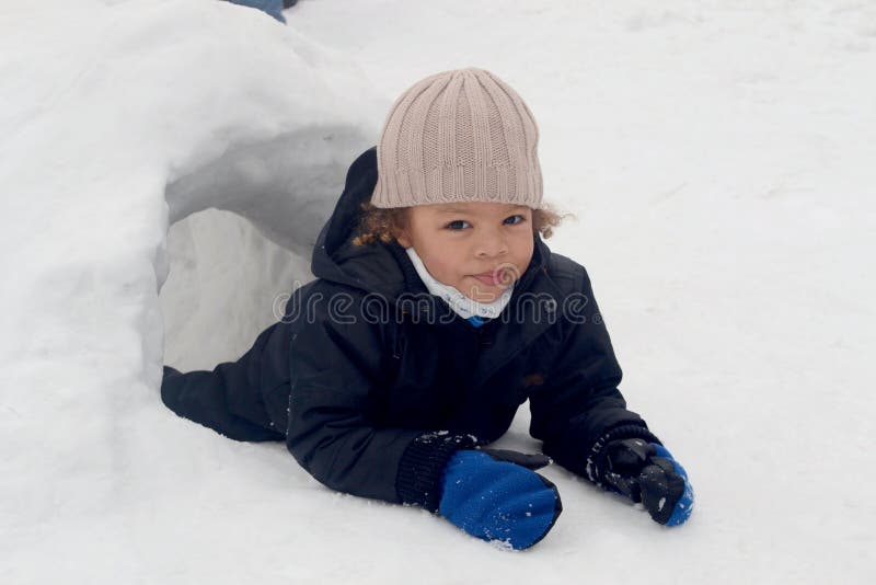 Boy in snow igloo