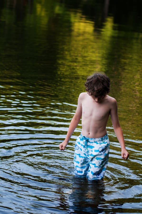 Boy standing in a lake