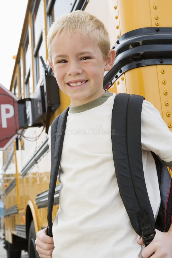 Boy Standing By School Bus