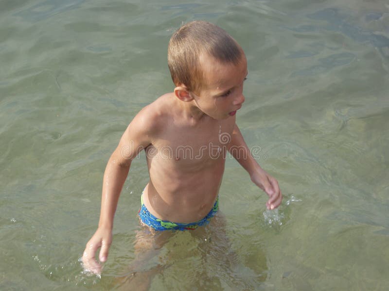 Boy standing wet in the water