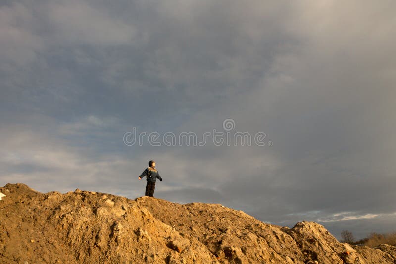 Boy stands on the hill in the early spring.