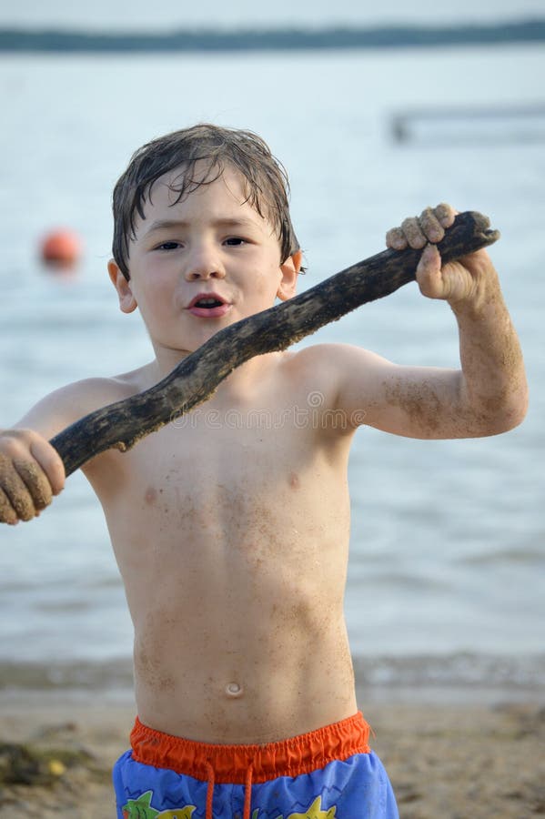 Boy with Stick at Beach