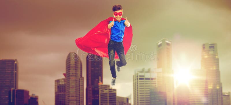 Boy in superhero cape and mask showing thumbs up royalty free stock images Boy in superhero cape and mask showing thumbs up royalty free stock images