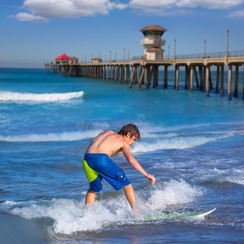 Boy surfer surfing waves on Huntinton beach royalty free stock image Boy surfer surfing waves on Huntinton beach royalty free stock image