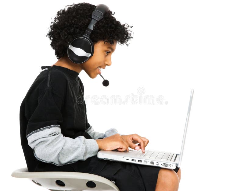 Boy surfing the net with headset and smiling isolated over white