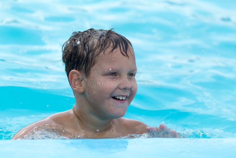 The Boy is Swimming in the Pool Stock Photo Image of cute, vacation
