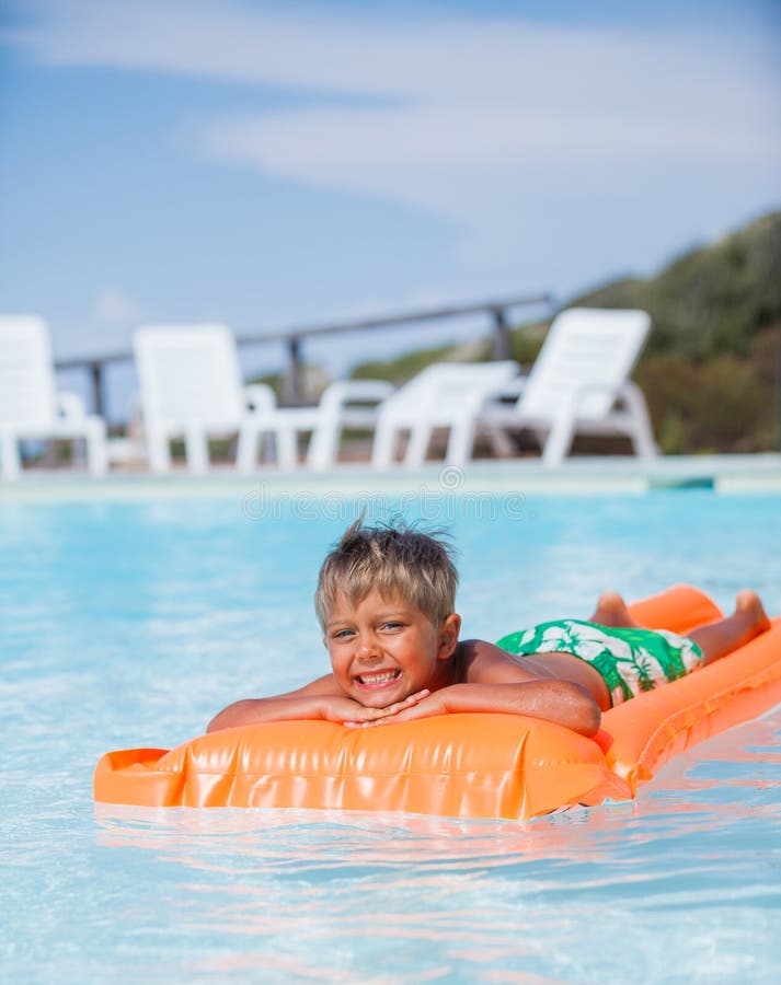 Boy at swimming pool stock photo. Image of relaxation 56663104