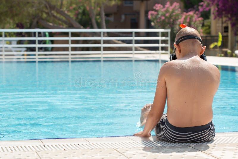 A boy in a swimming pool with a mask for snorkeling royalty free stock image A boy in a swimming pool with a mask for snorkeling royalty free stock image