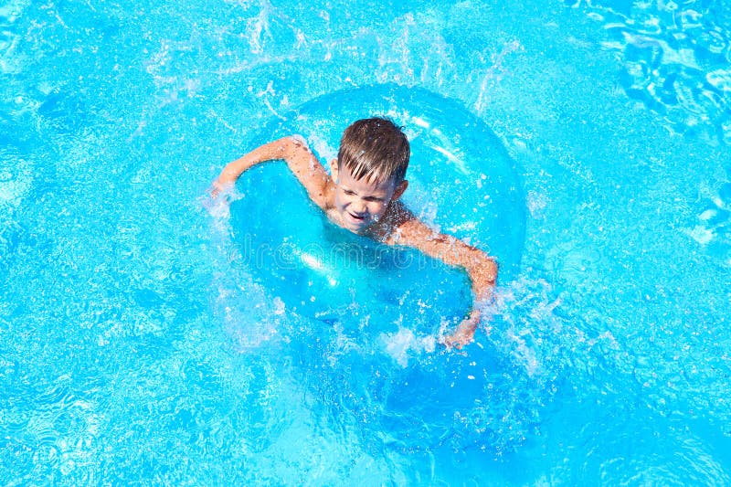 Boy swimming into pool stock image. Image of tropical 75835405