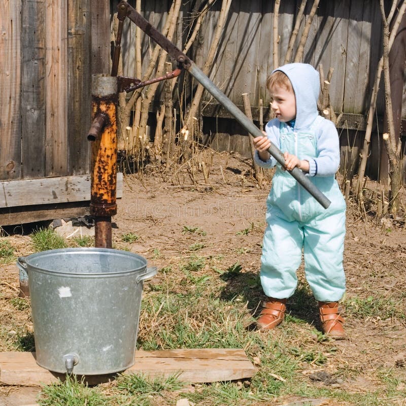 Boy takes water from a well in village (1)