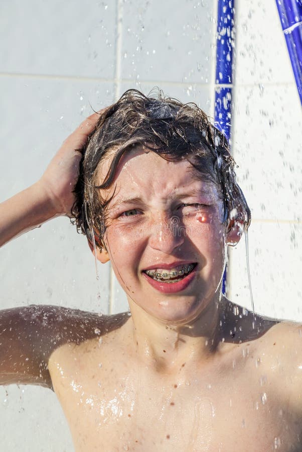 Boy is taking a shower at a pool