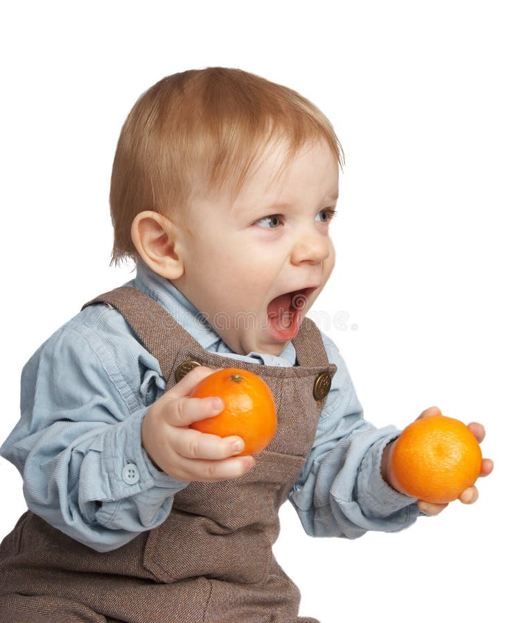 Boy with tangerines in hands