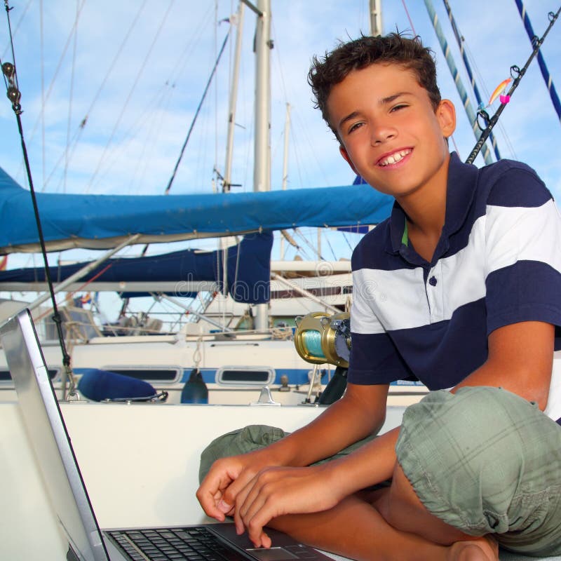 Boy teen seat on boat marina laptop computer