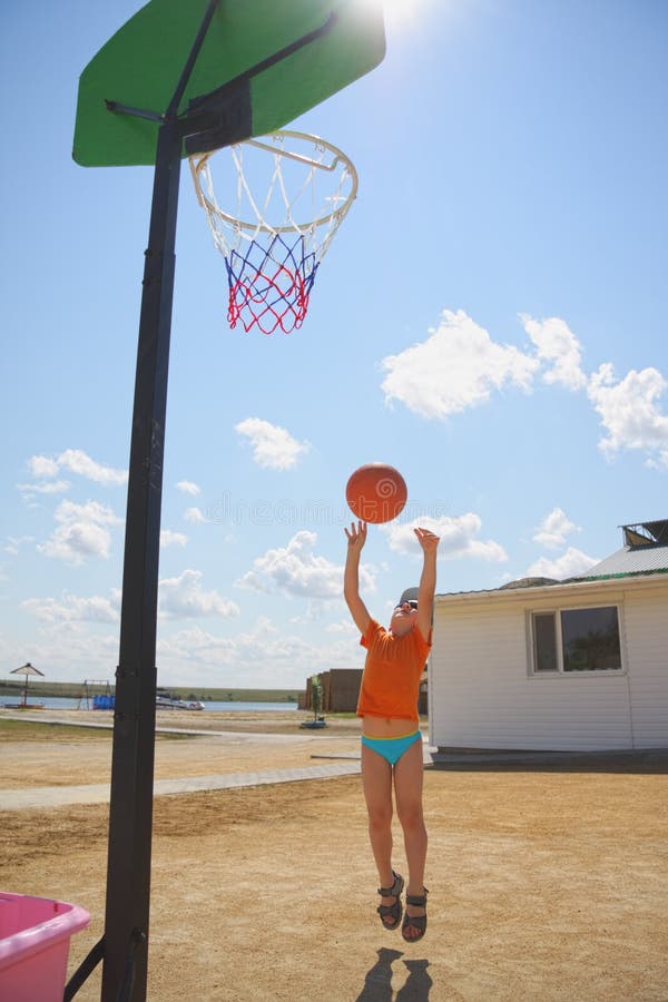 Boy throwing ball to basket royalty free stock photo Boy throwing ball to basket royalty free stock photo