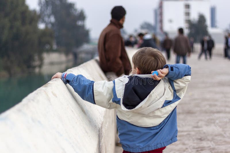 Boy Throwing Plastic Bottle Cap into the River Editorial Photo Image